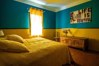 a bedroom with a bed and a window at Maison en campagne avec vues panoramiques - close to a lake in La Tour-dʼAigues