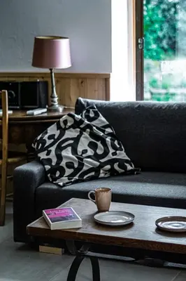 a living room with a couch and a coffee table at Maison en campagne avec vues panoramiques - close to a lake in La Tour-dʼAigues