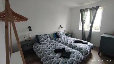 a bedroom with a bed and a couch with pillows at Une escapade en Luberon in Bonnieux