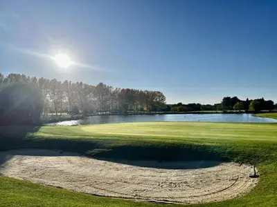 a view of a golf course with a pond at Maison de Vacances en Provence avec Piscine, Golf à Proximité, Fibre et Linge Haut de Gamme - FR-1-658-9 in Mallemort