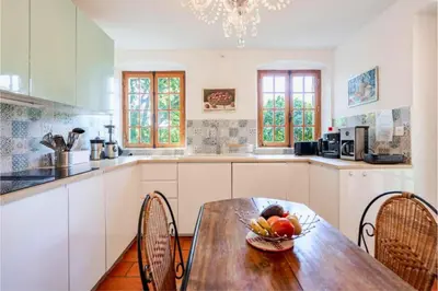 a kitchen with a table with a bowl of fruit on it at Joli mas 