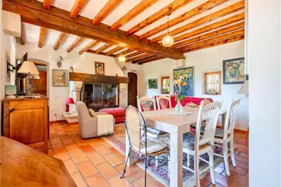 a kitchen and living room with a table and chairs at Joli mas 