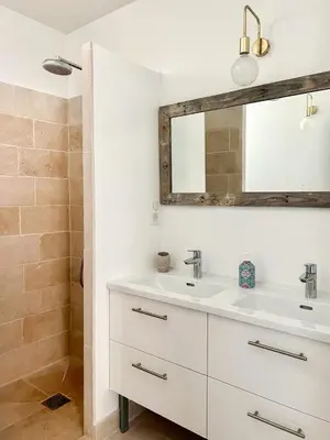 a bathroom with a white sink and a mirror at La Bohème à Lacoste in Lacoste