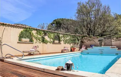 a swimming pool in a yard next to a house at Gorgeous Home In Vernègues in Vernègues