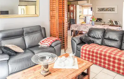a living room with two leather couches and a table at Gorgeous Home In Vernègues in Vernègues