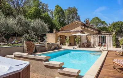 a swimming pool in a backyard with a house at Gorgeous Home In Vernègues in Vernègues