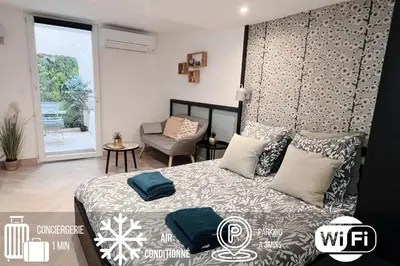 a bedroom with a bed and a chair at Le Petit Patio in Aix-en-Provence