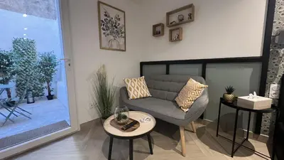 a living room with a couch and a table at Le Petit Patio in Aix-en-Provence