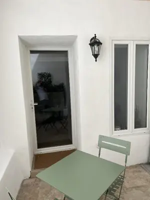 a white table in a room with a window at Le Petit Patio in Aix-en-Provence