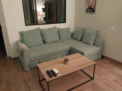 a living room with a green couch and a coffee table at Le Mistralet in Salon-de-Provence