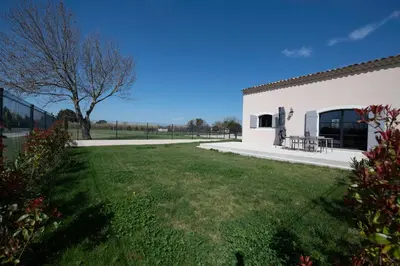 a building with a grassy yard next to a building at Maison Réglisse du MAS LOU CAPY in Salon-de-Provence