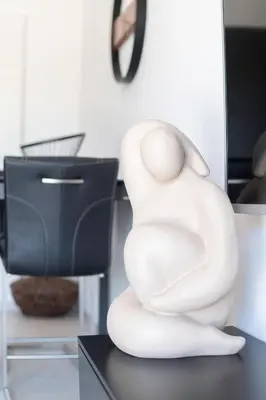 a white sculpture of a woman sitting on a desk at Maison Réglisse du MAS LOU CAPY in Salon-de-Provence