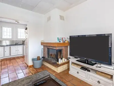 a living room with a large television and a fireplace at Holiday Home La Campagne des Ocres by Interhome in Rustrel