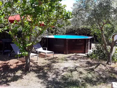 a table and two chairs in a yard with a pool at Holiday Home La Campagne des Ocres by Interhome in Rustrel
