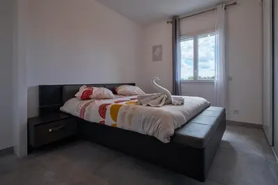 a bedroom with a large bed with a window at charming villa with heated pool, 14 people, located in aureille, near les baux de provence, in the alpilles in Aureille
