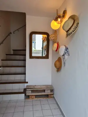 a hallway with a mirror and a bench and stairs at Lumineux Duplex au coeur de l'Isle in LʼIsle-sur-la-Sorgue