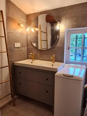 a bathroom with a sink and a mirror at Lumineux Duplex au coeur de l'Isle in LʼIsle-sur-la-Sorgue