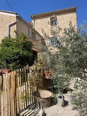 a fence in front of a house with plants at MAS-Calou in Coustellet