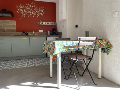 a table in a kitchen with a table cloth on it at MAS-Calou in Coustellet