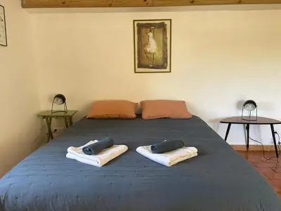 a blue bed with two pillows on top of it at MAS-Calou in Coustellet