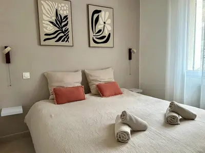 a bedroom with a large bed with towels on it at Une maison en Provence in Pierrevert