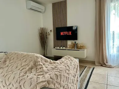 a bedroom with a bed and a tv on a wall at Une maison en Provence in Pierrevert
