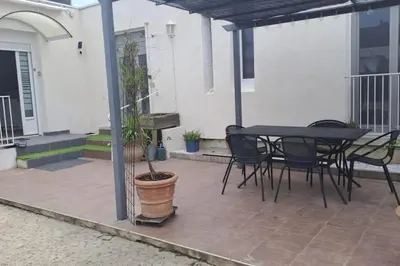 a patio with a table and chairs on a house at Maison paisible et ensoleillée in Avignon