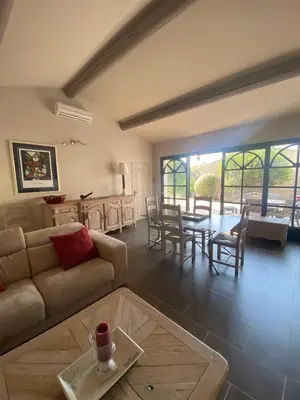 a living room with a couch and a table at Property with panoramic views in Cabrières-dʼAvignon