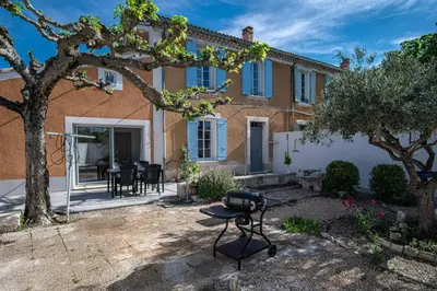 a house with a grill in the yard at Maison avec jardin proche du centre-ville Isle-sur-la-Sorgue in LʼIsle-sur-la-Sorgue