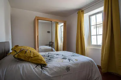 a bedroom with a bed and a mirror at Maison avec jardin proche du centre-ville Isle-sur-la-Sorgue in LʼIsle-sur-la-Sorgue