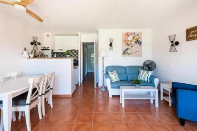a living room with a blue couch and a table at Village Pont Royal en Provence - maeva Home - Appartement décoré avec goût et climatisé 2 pièces 5 personnes - Prestige - super Home MAE-1144 in Mallemort