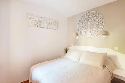 a bedroom with a bed and two pictures on the wall at Village Pont Royal en Provence - maeva Home - Appartement décoré avec goût et climatisé 2 pièces 5 personnes - Prestige - super Home MAE-1144 in Mallemort