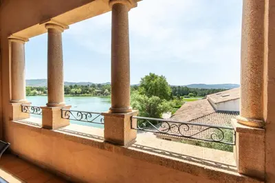 a balcony with a view of a river at Village Pont Royal en Provence - maeva Home - Appartement cosy et climatisé 3 pièces 6 personnes - Prestige - super Home MAE-3914 in Mallemort