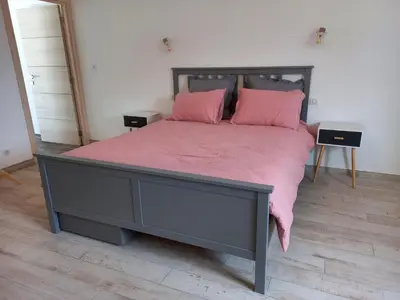 a bedroom with a large bed with pink sheets at A Ventoux Yourte in Monieux