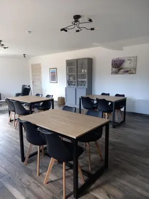 a group of tables and chairs in a room at A Ventoux Yourte in Monieux