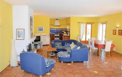a living room with blue chairs and a table at Amazing Home In Roussillon With Wifi in Roussillon