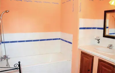 a bathroom with a tub and a sink at Amazing Home In Roussillon With Wifi in Roussillon