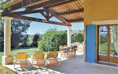 a patio with chairs and a table with a view of a yard at Amazing Home In Roussillon With Wifi in Roussillon