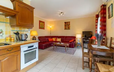 a kitchen and living room with a red couch at Beautiful Home In Lauris With Wifi in Lauris