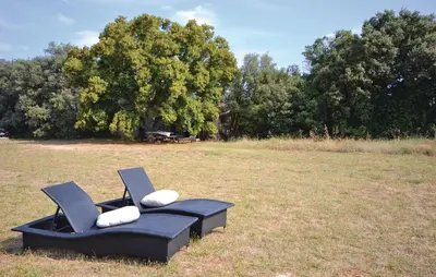a black couch sitting in the middle of a field at 1 Bedroom Beautiful Home In Saignon in Saignon
