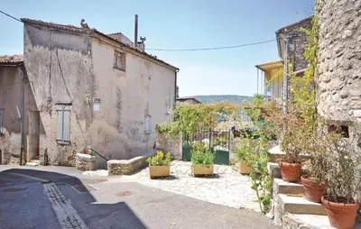 an alley with potted plants on the side of a building at 3 Bedroom Cozy Home In Sault in Sault-de-Vaucluse