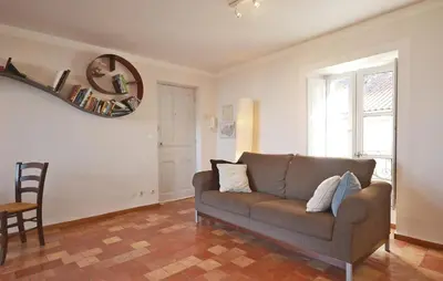 a living room with a couch and a mirror at Cozy Apartment In Bonnieux With Kitchen in Bonnieux