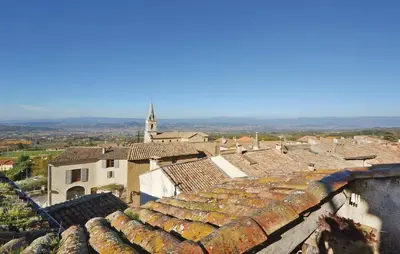 a view of a town with roofs and a church at Cozy Apartment In Bonnieux With Kitchen in Bonnieux