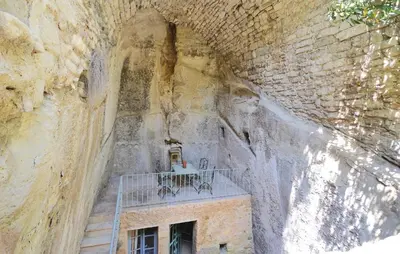 a table on a balcony in a stone wall at 3 Bedroom Nice Home In Bonnieux in Bonnieux