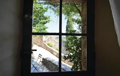 an open window with a view of a pathway at 3 Bedroom Nice Home In Bonnieux in Bonnieux