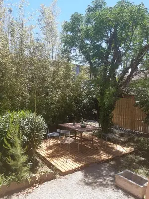 a picnic table and chairs in a garden at Villa 