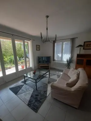 a living room with a white couch and a glass table at Villa 