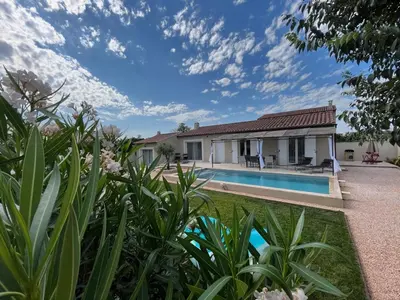 a house with a swimming pool in a yard at Villa Provençale avec Piscine Chauffée in Saint-Andiol