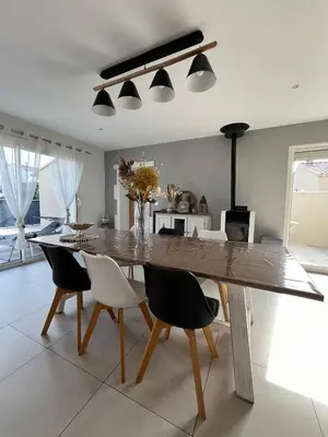 a dining room with a large wooden table and chairs at Villa Provençale avec Piscine Chauffée in Saint-Andiol