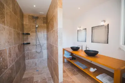 a bathroom with two sinks and a shower at LE PETIT CHENE in Apt